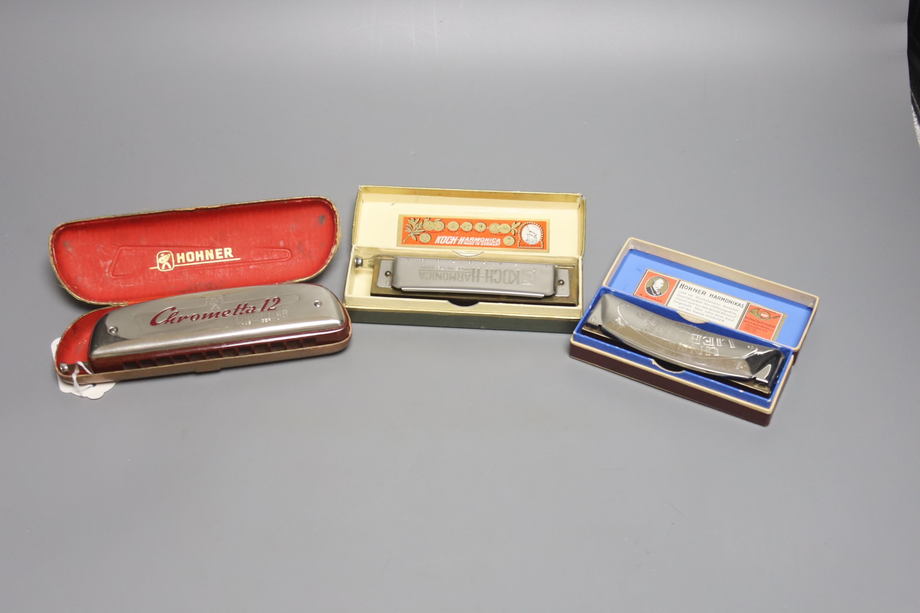 Three cased Hohner harmonicas, Chrometta 12, Koch and Lieblinge
